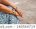 Indian woman wearing traditional gold bangles and rings. 140564719
