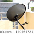Satellite TV Dish Antenna Mounted on a Rooftop 140564721