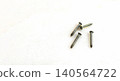 Small Metal Screws on White Background with copy space for text 140564722
