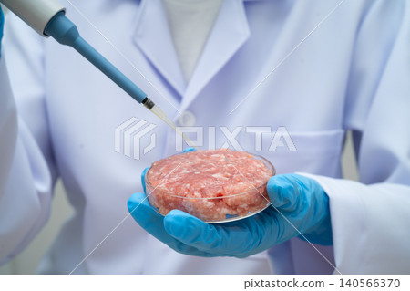 Scientist holding Petri dish with meat in science laboratory for food product development. Scientist holding Petri dish with meat in science laboratory for food product development. 140566370