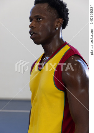 African american male athlete breathing heavily on court wearing jersey, copy space African american male athlete breathing heavily on court wearing jersey, copy space 140566824