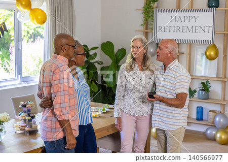 Two senior couples holding trophy celebrating retirement at table in dining area, copy space Two senior couples holding trophy celebrating retirement at table in dining area, copy space 140566977