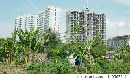 Land grabbing high rise building constructed modern condo towers construction houses land juxtaposition commercial and residential area over populated population cluster of building and houses urban Land grabbing high rise building constructed modern condo towers construction houses land juxtaposition commercial and residential area over populated population cluster of building and houses urban 140567242