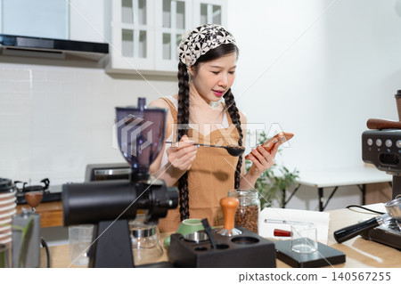 Young barista making coffee, coffee preparation service concept. 140567255