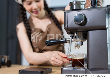 Young barista making coffee, coffee preparation service concept. Young barista making coffee, coffee preparation service concept. 140567279