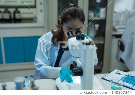 Team Asian environmental scientists analyzing water quality samples with centrifuge and petri dish in laboratory. Team Asian environmental scientists analyzing water quality samples with centrifuge and petri dish in laboratory. 140567344