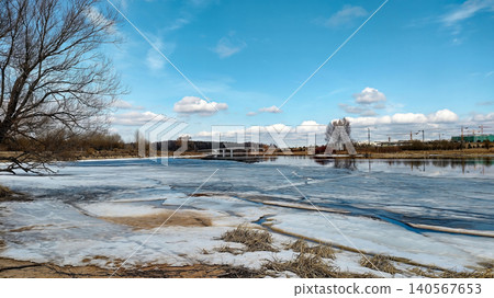 A stunning springtime landscape featuring a wide river with melting ice floes. A stunning springtime landscape featuring a wide river with melting ice floes. 140567653