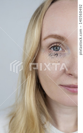 Woman demonstrating easy tubing mascara removal process using warm water. Woman washing off innovative thermal cosmetics that slides off eyelashes in tubes without smudging Woman demonstrating easy tubing mascara removal process using warm water. Woman washing off innovative thermal cosmetics that slides off eyelashes in tubes without smudging 140568492