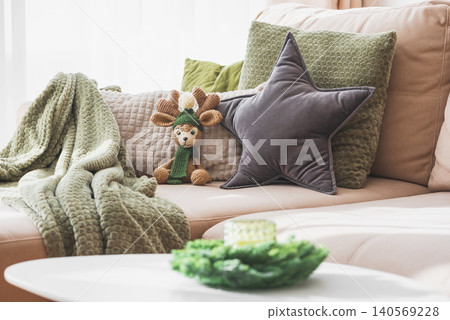 Cozy living room sofa with pillows and deer toy Cozy living room sofa with pillows and deer toy 140569228