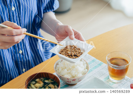A young woman's hands as she eats natto A young woman's hands as she eats natto 140569289