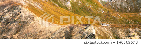 Mountain ridge with blue cloudy sky. Mountain landscape with day sky and clouds. Grossglockner High Alpine Road. Austria Mountain ridge with blue cloudy sky. Mountain landscape with day sky and clouds. Grossglockner High Alpine Road. Austria 140569578
