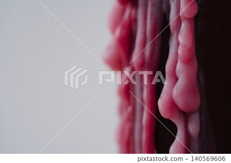 Closeup of melted red wax texture on light background 140569606