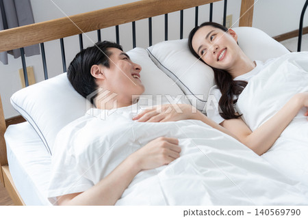 A middle-aged couple sleeping in the bedroom 140569790