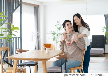 A middle-aged couple relaxing in the living room A middle-aged couple relaxing in the living room 140569830