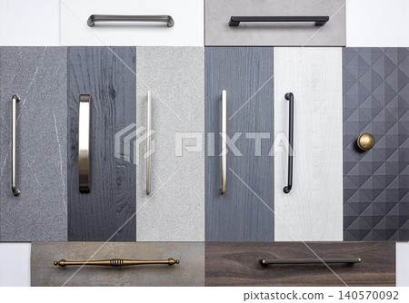 Variety of cabinet handles displayed on different surfaces in a kitchen setting for interior design choices Variety of cabinet handles displayed on different surfaces in a kitchen setting for interior design choices 140570092