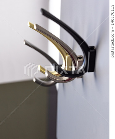 Wall hooks in various colors used for hanging items in a room Wall hooks in various colors used for hanging items in a room 140570115