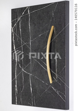 Modern cabinet door design with simple handle in black and white marble pattern at an indoor setting 140570116