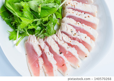 Rare-cooked tuna steak served with baby greens. Rare-cooked tuna steak served with baby greens. 140570268
