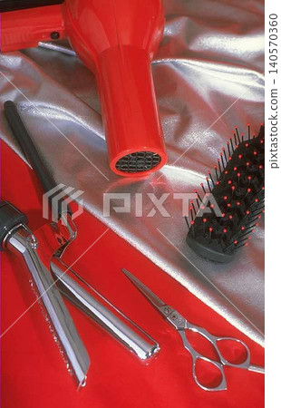 Hair Styling Tools Set with Blow Dryer, Brush and Scissors on Red Surface Hair Styling Tools Set with Blow Dryer, Brush and Scissors on Red Surface 140570360