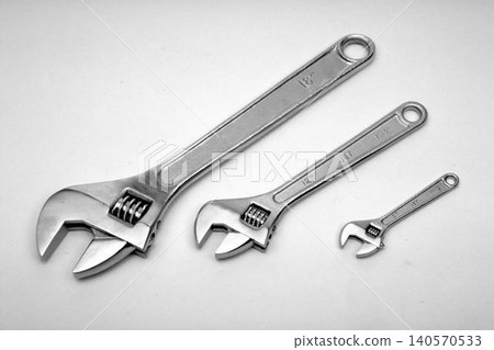 A realistic image of a Three Adjustable Pipe Wrenches in Different Sizes 140570533