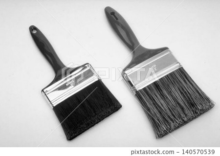 A realistic image of a Two Paint Brushes with Black Handles A realistic image of a Two Paint Brushes with Black Handles 140570539