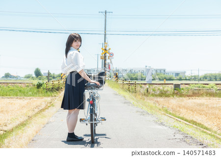 School girls riding a bicycle 140571483