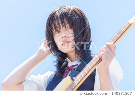 School girls playing the guitar School girls playing the guitar 140571507