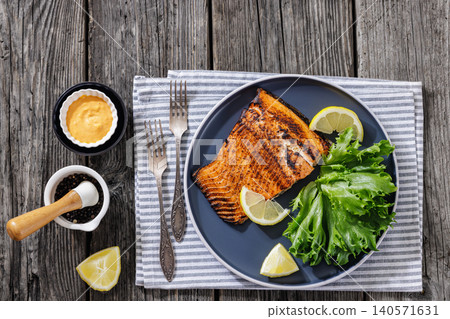 Salmon fillet grilled dinner on wooden background 140571631