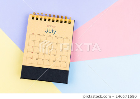 July 2027 desk calendar from brown paper on colorful background, Position with empty space. July 2027 desk calendar from brown paper on colorful background, Position with empty space. 140571680