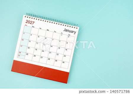 January 2027 desk calendar on blue background for your appointment. January 2027 desk calendar on blue background for your appointment. 140571786
