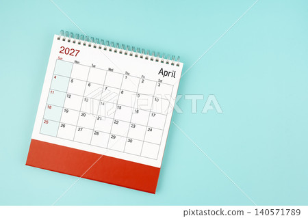 April 2027 desk calendar on blue background for your appointment. April 2027 desk calendar on blue background for your appointment. 140571789