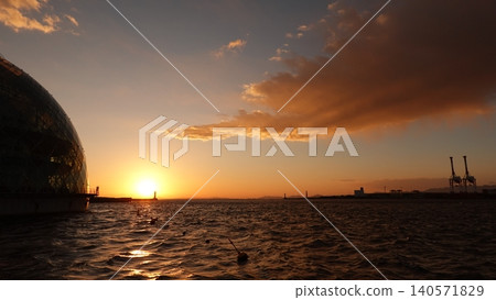 A dome-shaped building floating on the sea and a beautiful sunset. A dome-shaped building floating on the sea and a beautiful sunset. 140571829