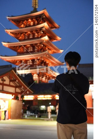 A man standing with a five-story pagoda in the background. A man standing with a five-story pagoda in the background. 140572504