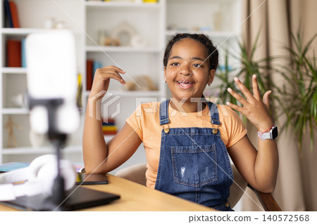 Black teenage girl recording video or participating in online presentation from home Black teenage girl recording video or participating in online presentation from home 140572568