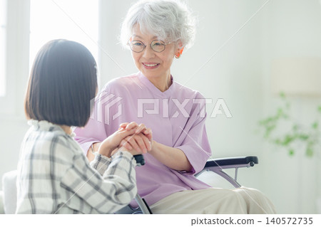 Grandchild visiting grandmother in the hospital Grandchild visiting grandmother in the hospital 140572735