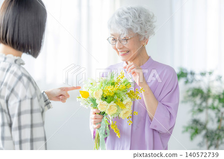 A grandchild gives a bouquet of flowers on Respect for the Aged Day A grandchild gives a bouquet of flowers on Respect for the Aged Day 140572739
