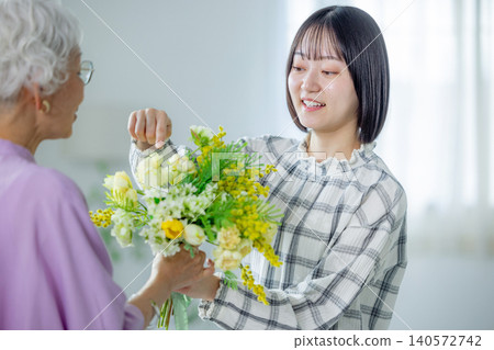 A grandchild gives a bouquet of flowers on Respect for the Aged Day 140572742