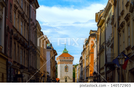Charming historical street view featuring a watchtower and lined buildings Charming historical street view featuring a watchtower and lined buildings 140572903