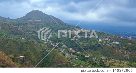 misty aerial panorama tropic country side landscape living log cabins and mountains in stormy time 140572905