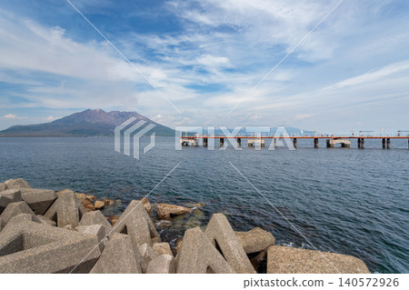 A view of the sea fishing park and Sakurajima volcano from near the Kamoike Long Waterway. 140572926