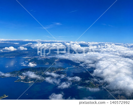 The sea and islands visible through gaps in the clouds The sea and islands visible through gaps in the clouds 140572992