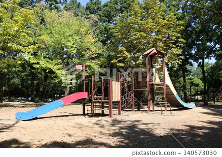 A peaceful playground scene in Kiba Park, surrounded by trees. A peaceful playground scene in Kiba Park, surrounded by trees. 140573030