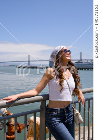Young woman enjoying waterfront view near Bay Bridge in San Francisco Young woman enjoying waterfront view near Bay Bridge in San Francisco 140573153