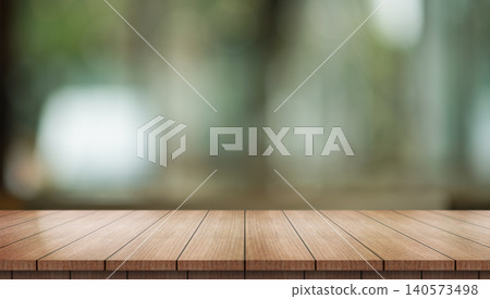 Empty wooden table top with lights bokeh on blur restaurant background. Empty wooden table top with lights bokeh on blur restaurant background. 140573498