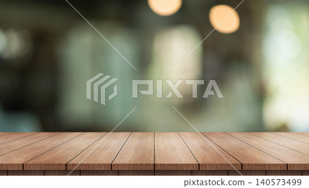 Empty wooden table top with lights bokeh on blur restaurant background. Empty wooden table top with lights bokeh on blur restaurant background. 140573499