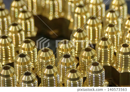 Mass production of precision brass fitting parts manufactured by an automated CNC lathe machine. Mass production of precision brass fitting parts manufactured by an automated CNC lathe machine. 140573563