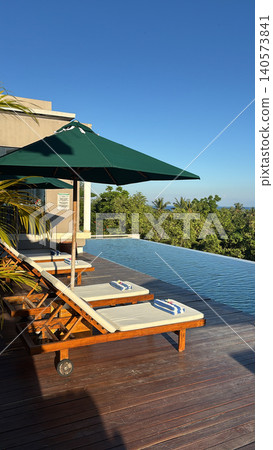 Luxurious infinity pool terrace with tropical forest and ocean views. Luxurious infinity pool terrace with tropical forest and ocean views. 140573841