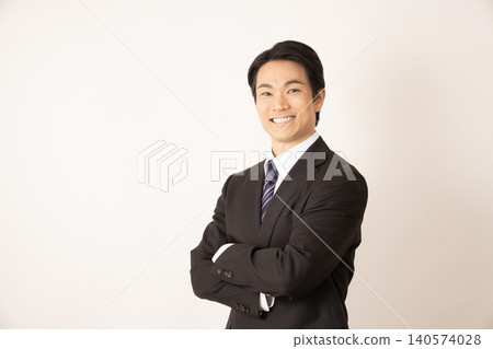 A man with his arms crossed, smiling. A man with his arms crossed, smiling. 140574028