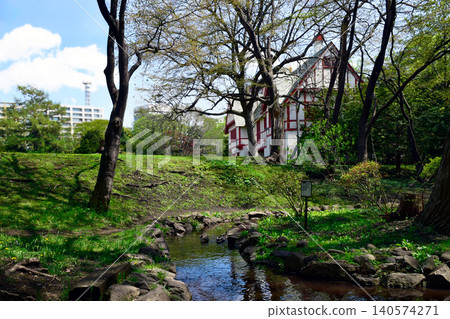 The Hokkaido Governor's Residence (formerly the Mitsui Club) and its lush green gardens, viewed across a stream. 140574271