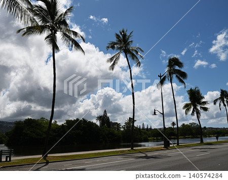 Palm trees along the Ala Wai Canal and a blue sky: A Honolulu scene. Palm trees along the Ala Wai Canal and a blue sky: A Honolulu scene. 140574284
